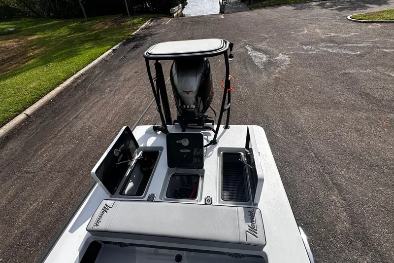 Slide: The Image of 2022 Maverick 17 HPX-V boat with open compartments and outboard motor at a boat ramp. - 29