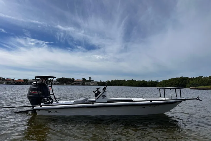 Slide: The Image of 2022 Maverick 17 HPX-V boat on calm water under a cloudy sky. - 3
