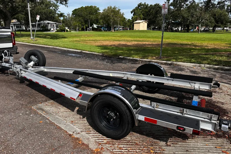 Slide: The Image of Trailer for 2022 Maverick 17 HPX-V boat parked on a street near a grassy area. - 32