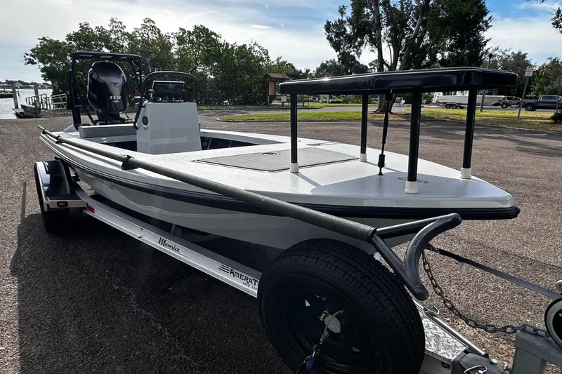 Slide: The Image of 2022 Maverick 17 HPX-V boat on trailer, parked near a waterfront. - 6