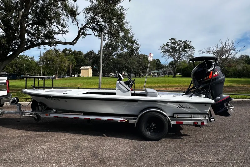 Slide: The Image of 2022 Maverick 17 HPX-V boat on trailer, parked outdoors near grassy area. - 8