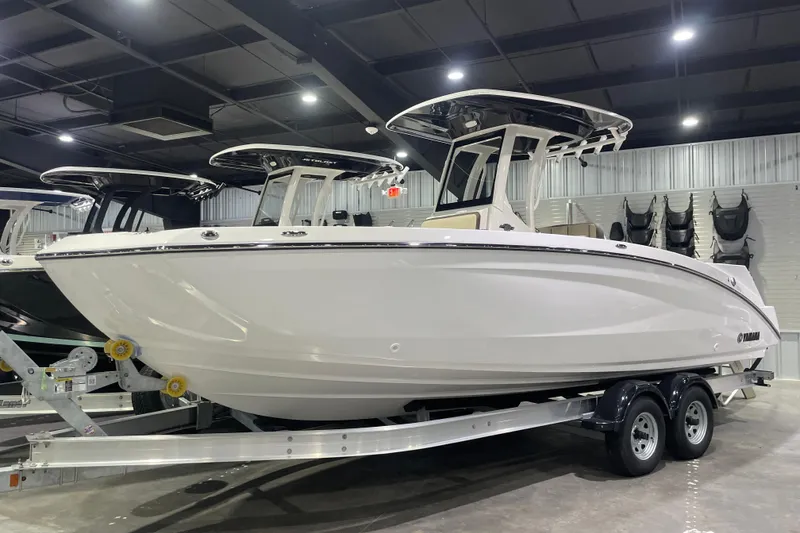 Slide: The Image of 2025 Yamaha Boats 252 FSH Sport on trailer in showroom, side view. - 0