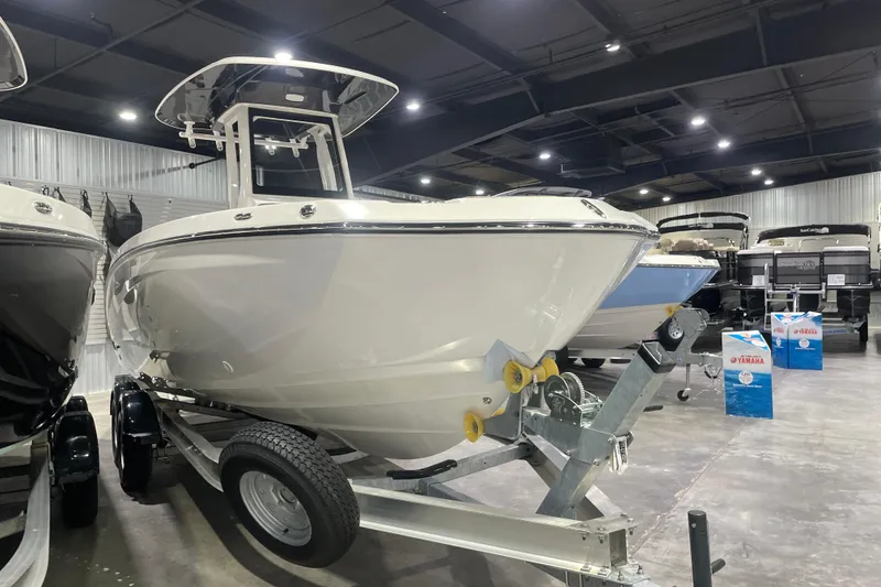 Slide: The Image of 2025 Yamaha Boats 252 FSH Sport displayed in a showroom on a trailer. - 1