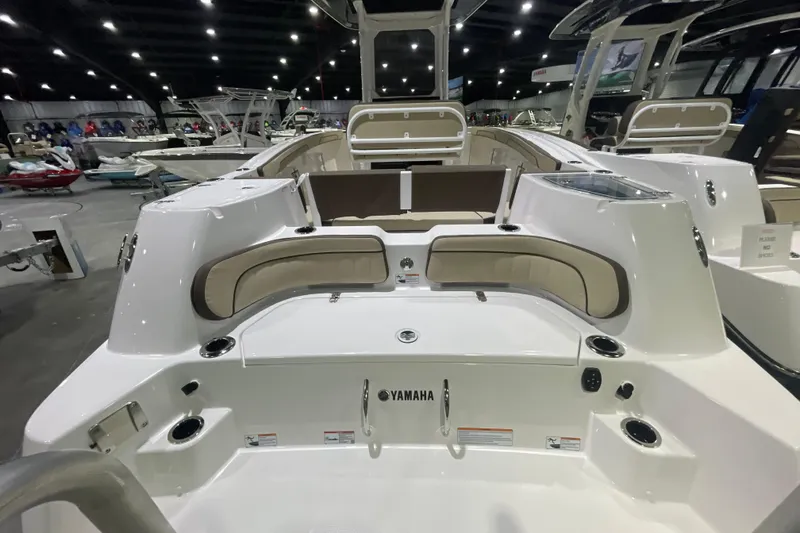 Slide: The Image of 2025 Yamaha Boats 252 FSH Sport interior at a boat show, showcasing seating and design. - 4