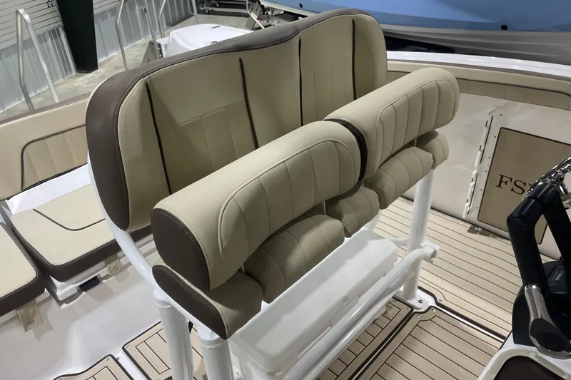 Slide: The Image of 2025 Yamaha Boats 252 FSH Sport interior with beige seating and helm station. - 7