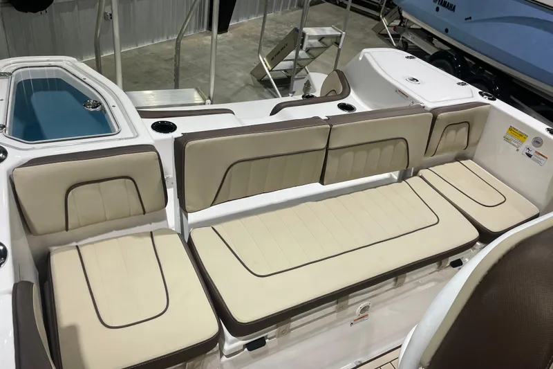 Slide: The Image of 2025 Yamaha Boats 252 FSH Sport interior with beige seating and storage compartments. - 8