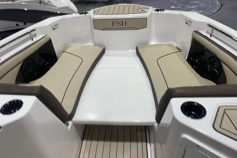 Slide: The Image of 2025 Yamaha Boats 252 FSH Sport interior with beige seating and cup holders. - 9