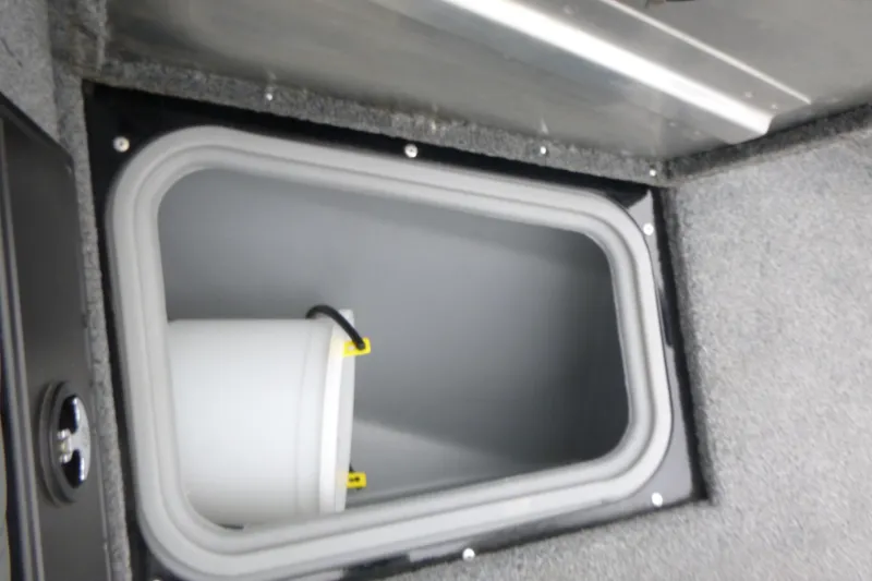 Slide: The Image of Storage compartment in 2019 Tracker Pro Guide V-175 Combo boat with a white bucket. - 11