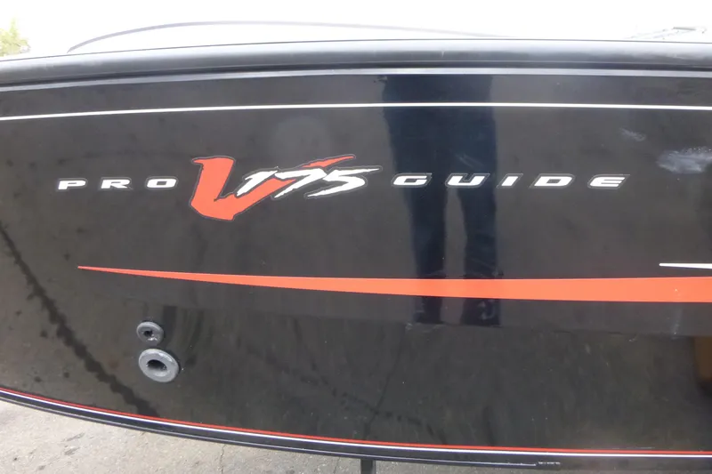 Slide: The Image of 2019 Tracker Pro Guide V-175 Combo boat with sleek black and red design. - 19