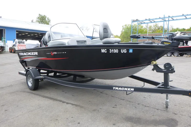 Slide: The Image of 2019 Tracker Pro Guide V-175 Combo boat on trailer, parked outdoors. - 3