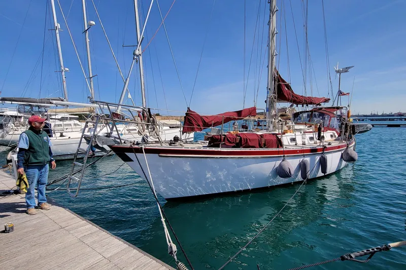 Slide: The Image of 1988 Tayana Vancouver 42 sailboat docked at marina, clear blue sky, calm water. - 13