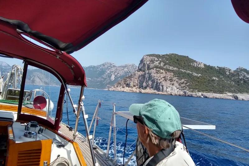 Slide: The Image of Sailing on a 1988 Tayana Vancouver 42 yacht near rocky coastline under clear skies. - 14