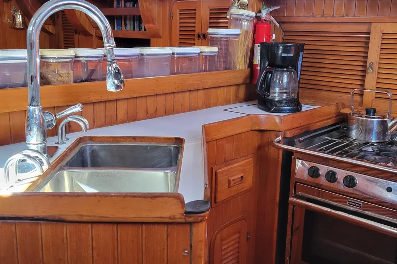 Slide: The Image of Galley kitchen in 1988 Tayana Vancouver 42 yacht with sink, stove, and coffee maker. - 18