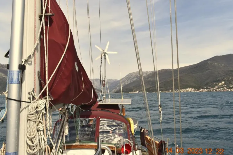 Slide: The Image of Sailing on a 1988 Tayana Vancouver 42 with mountains in the background. - 3