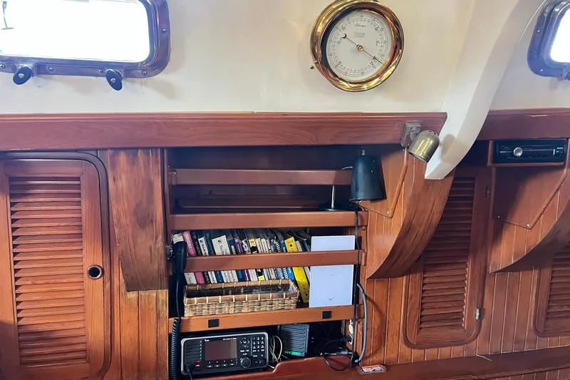 Slide: The Image of Interior of a 1988 Tayana Vancouver 42 yacht with wood paneling and control panel. - 34