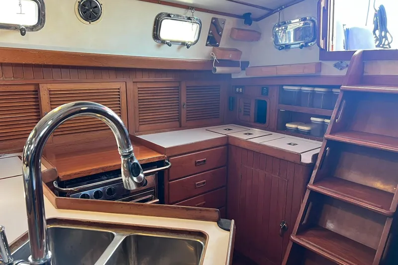 Slide: The Image of Interior of 1988 Tayana Vancouver 42 with bookshelf and barometer. - 35