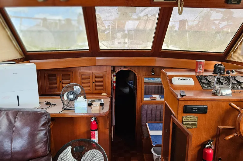 Slide: The Image of Interior of 1985 CHB 48 Motor Yacht with helm, seating, and navigation equipment. - 30
