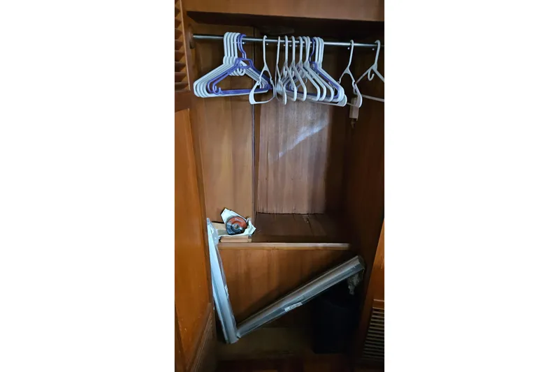 Slide: The Image of Wooden closet with hangers inside a 1985 CHB 48 Motor Yacht. - 60