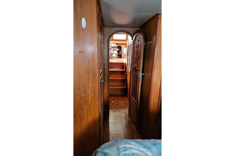 Slide: The Image of Interior hallway of 1985 CHB 48 Motor Yacht with wooden paneling and decorative door. - 63