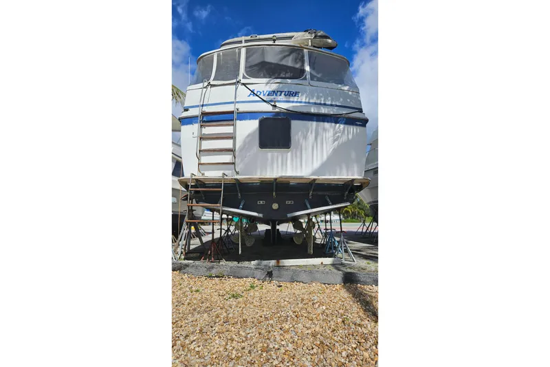 Slide: The Image of 1985 CHB 48 Motor Yacht on dry dock, showcasing rear view and ladder. - 71