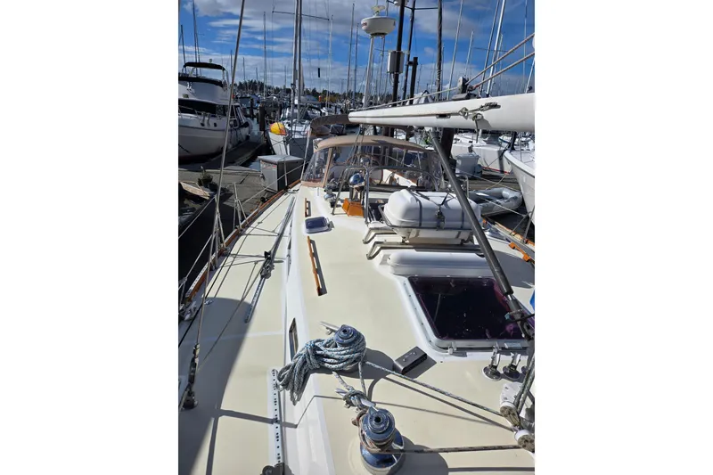 Slide: The Image of 1986 Cambria 46 sailboat docked in a marina, showcasing deck and rigging. - 13
