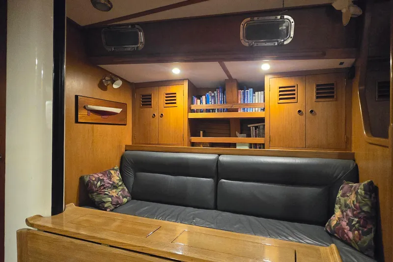 Slide: The Image of Interior of 1986 Cambria 46 yacht with cozy seating and wooden cabinetry. - 25