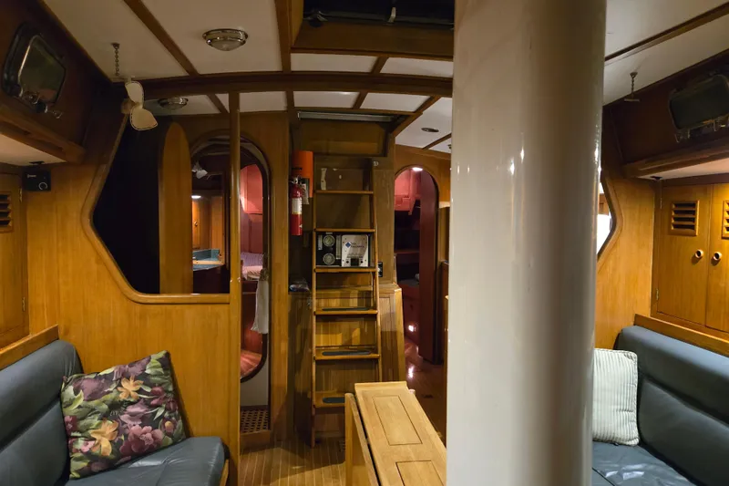 Slide: The Image of Interior of 1986 Cambria 46 yacht with wooden furnishings and cozy seating area. - 26