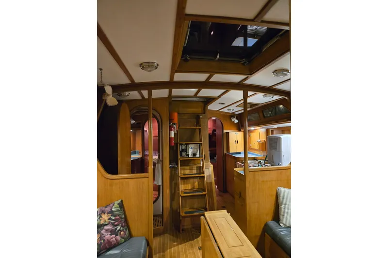 Slide: The Image of Interior of 1986 Cambria 46 yacht, featuring wooden furnishings and cozy seating area. - 27