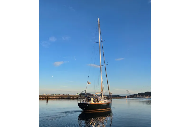 Slide: The Image of Sailboat Cambria 46 from 1986 on calm water under clear blue sky. - 3