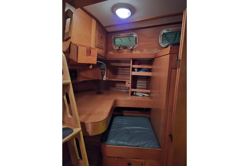 Slide: The Image of Interior of 1986 Cambria 46 sailboat with wooden cabinetry and seating area. - 30