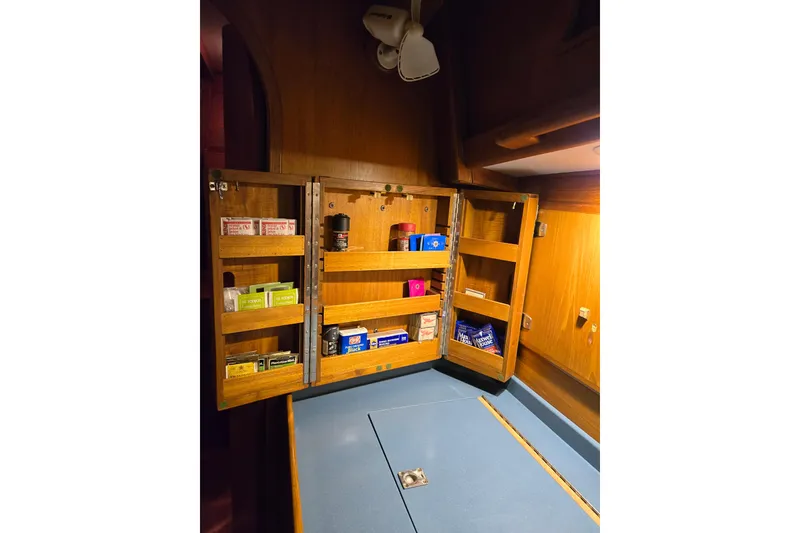 Slide: The Image of Wooden cabinet with open shelves in a 1986 Cambria 46 yacht interior. - 35