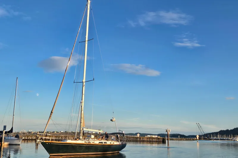Slide: The Image of Sailboat Cambria 46 from 1986 on calm water under a clear blue sky. - 6