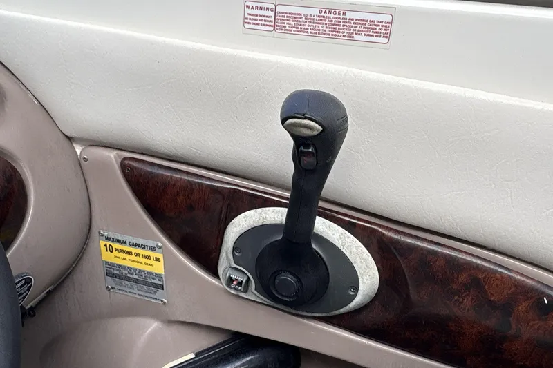 Slide: The Image of 2002 Regal 2400 Bowrider throttle control and capacity warning label. - 10