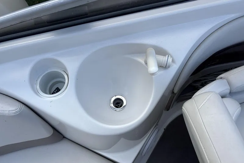 Slide: The Image of 2002 Regal 2400 Bowrider boat interior with sink and cup holder. - 17