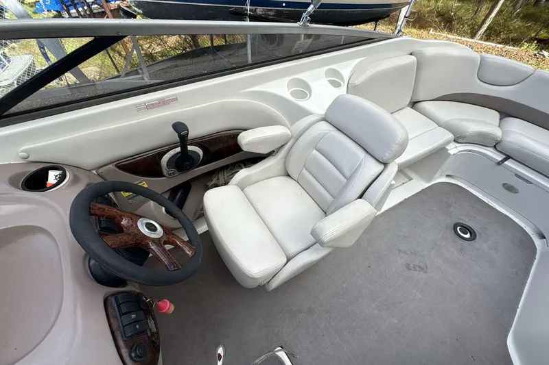 Slide: The Image of 2002 Regal 2400 Bowrider interior with steering wheel and white seating. - 7