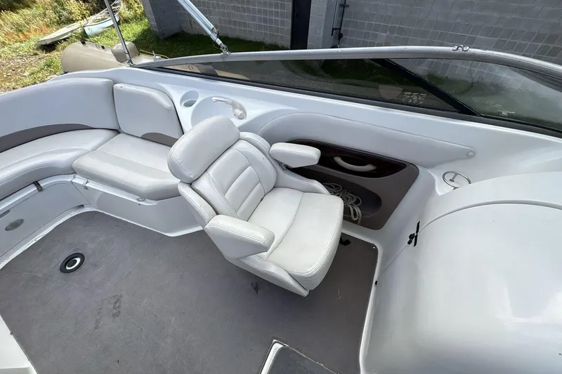 Slide: The Image of 2002 Regal 2400 Bowrider interior with white seating and steering area. - 8