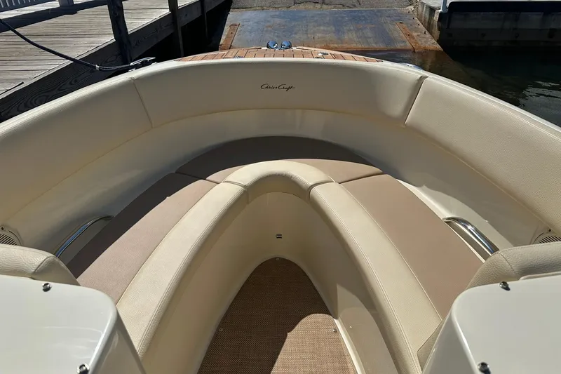 Slide: The Image of 2018 Chris-Craft Launch 27 boat interior with beige seating and wooden accents. - 14