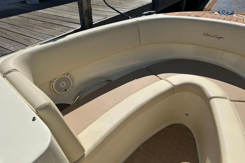 Slide: The Image of 2018 Chris-Craft Launch 27 boat interior with beige seating and speaker detail. - 15