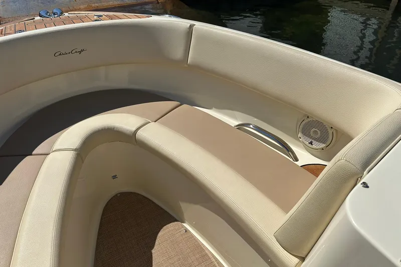 Slide: The Image of 2018 Chris-Craft Launch 27 boat interior with beige seating and speaker detail. - 16