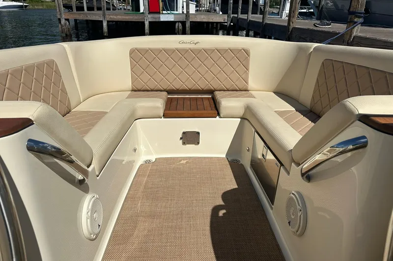 Slide: The Image of 2018 Chris-Craft Launch 27 interior with beige quilted seating and wood accents. - 21