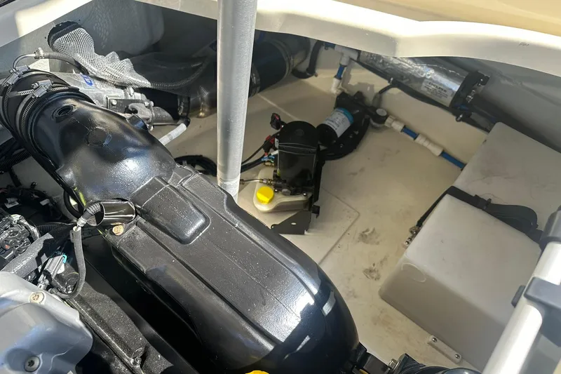 Slide: The Image of Engine compartment of a 2018 Chris-Craft Launch 27 boat, showcasing mechanical components. - 25