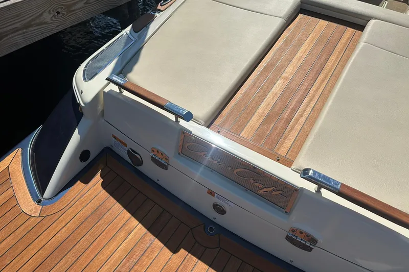 Slide: The Image of 2018 Chris-Craft Launch 27 boat with teak deck and cushioned seating. - 6