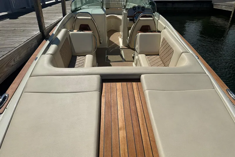 Slide: The Image of 2018 Chris-Craft Launch 27 boat interior with luxurious seating and wooden deck. - 7
