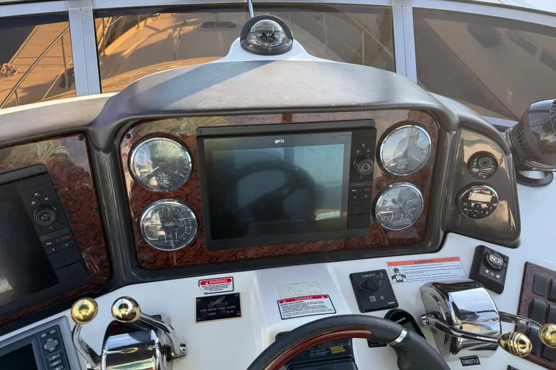 Slide: The Image of 2007 Sea Ray 44 Sedan Bridge dashboard with navigation controls and gauges. - 12