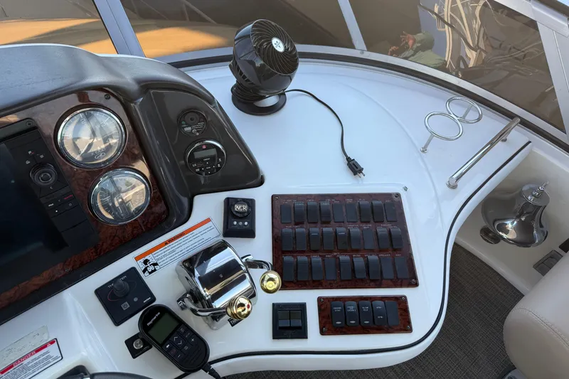 Slide: The Image of Control panel of a 2007 Sea Ray 44 Sedan Bridge yacht with gauges and switches. - 13