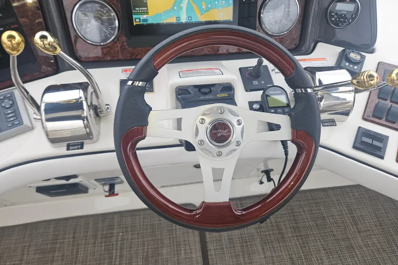Slide: The Image of Steering wheel and controls of 2007 Sea Ray 44 Sedan Bridge yacht. - 14