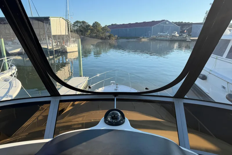 Slide: The Image of View from 2007 Sea Ray 44 Sedan Bridge helm, overlooking marina and calm waters. - 15