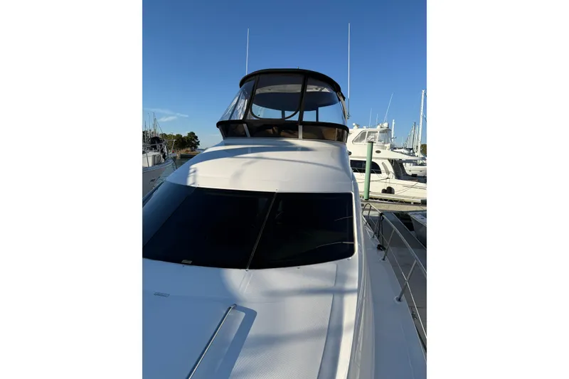 Slide: The Image of 2007 Sea Ray 44 Sedan Bridge yacht docked at marina under clear blue sky. - 21