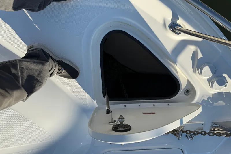 Slide: The Image of 2007 Sea Ray 44 Sedan Bridge deck with open hatch and foot visible. - 23