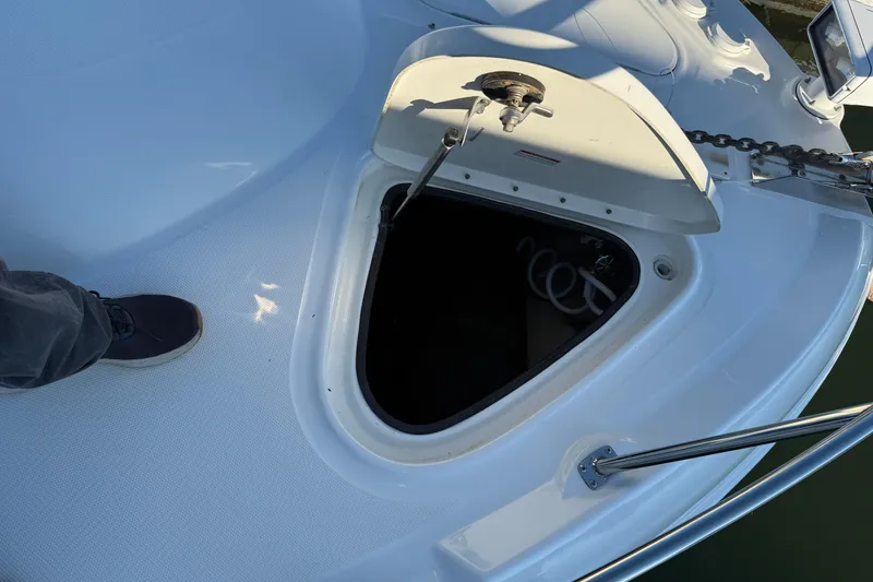 Slide: The Image of 2007 Sea Ray 44 Sedan Bridge anchor locker with open hatch and visible chain. - 24
